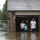 People wait to be rescued from their flooded home after Hurricane Harvey.